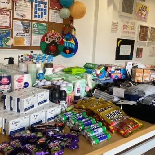 Shelves filled with toiletries, snacks and essential items used to fill Hope Bags